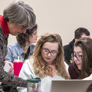 Professor Gabrenya from Sage's criminal justice degree program assists students.