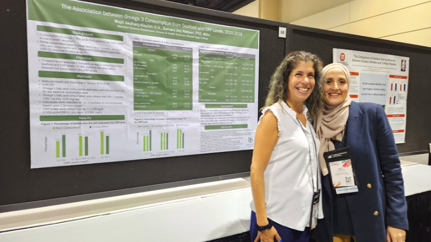 Nutrition graduate student Majd Jauhary-Nayfeh and Samara Joy Nielsen with their poster at the FNCE conference.