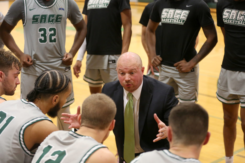 Men's basketball coach and student-athletes during game