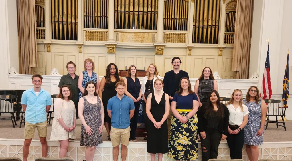 A group of Russell Sage students standing with faculty in Bush Memorial building.