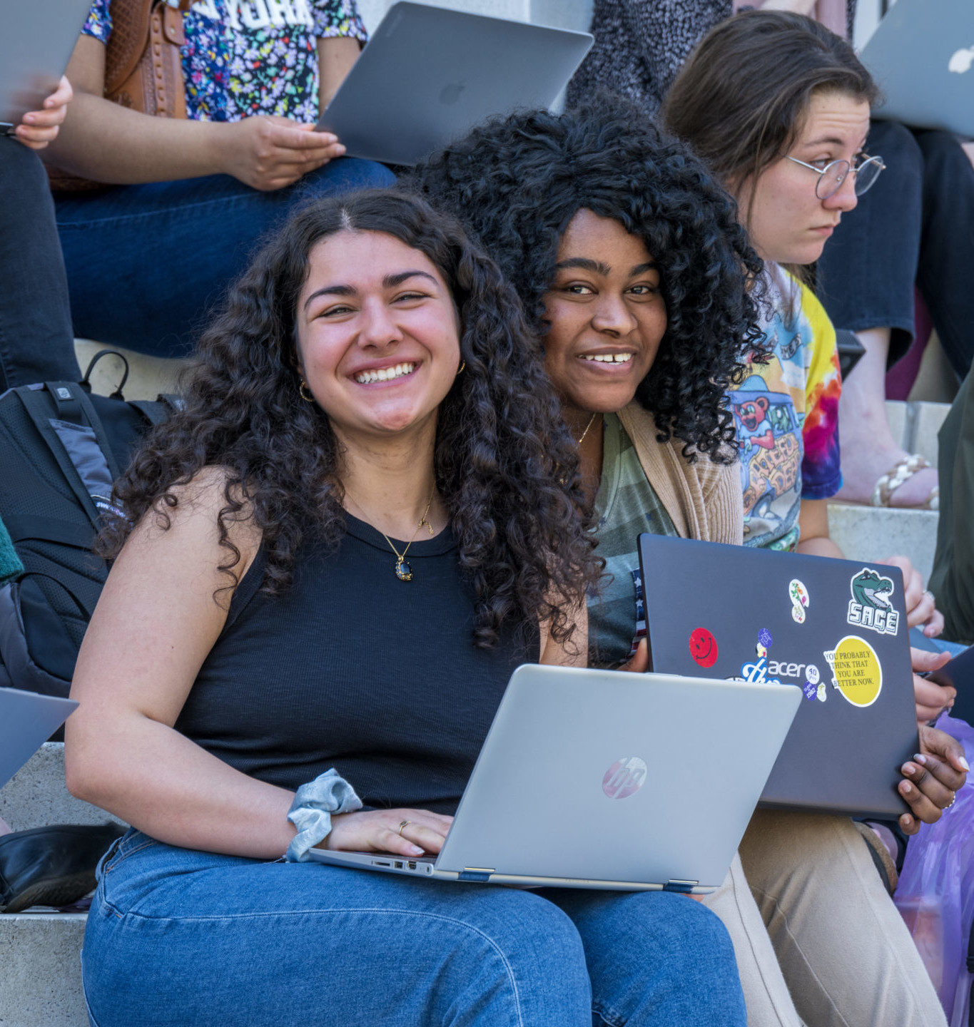 Students with laptops on steps of Bush Memorial Hall.