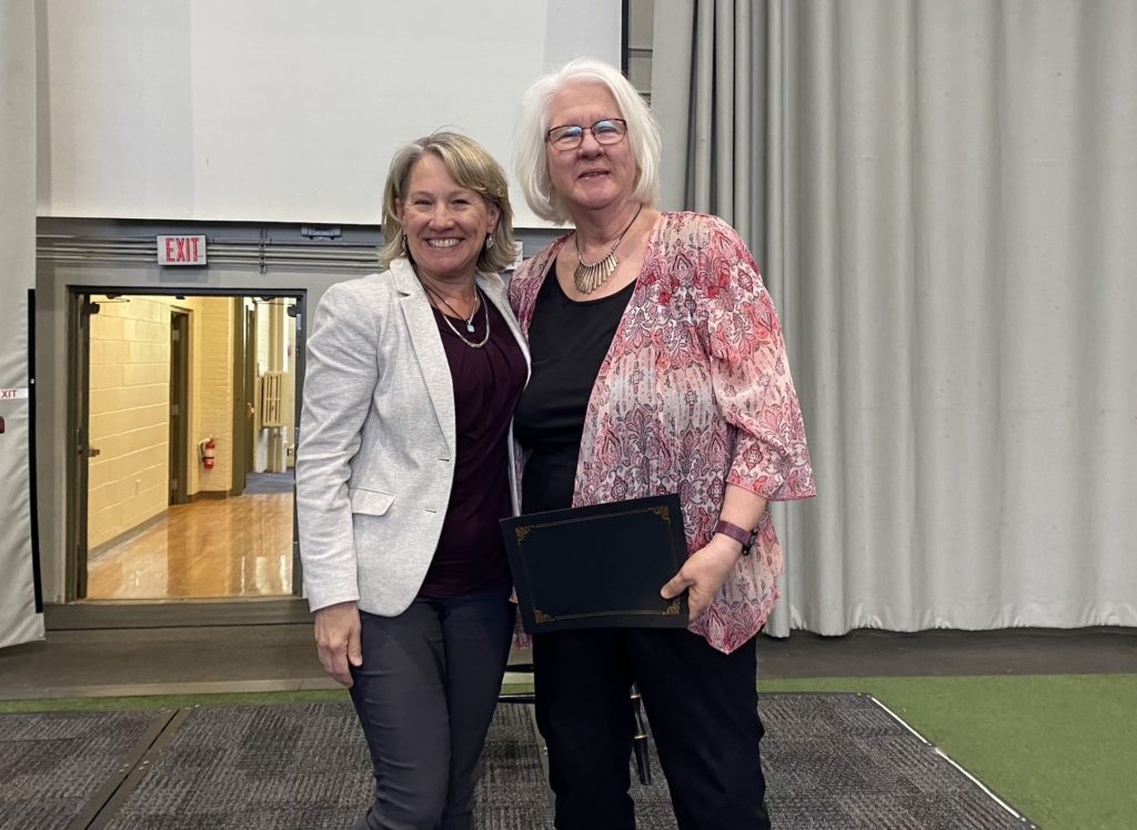 Margot Elacqua, OTD, MBA, OTR/L, associate professor of occupational therapy, who is retiring after 21 years with Russell Sage, stands with Provost Theresa Hand.