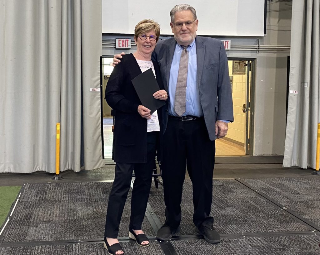 Rose Grignon, chief of staff and executive assistant to the president for 45 years, celebrates her retirement with President Christopher Ames.