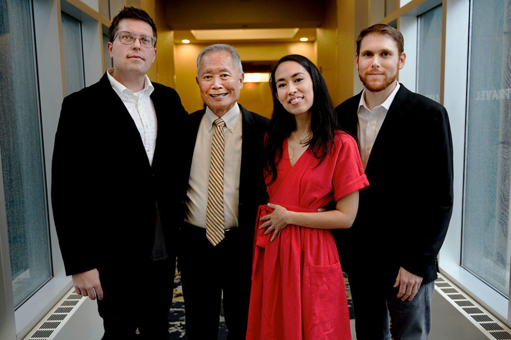 Justin Eisinger, George Takei, Harmony Becker and Steven Scott standing in formal wear.
