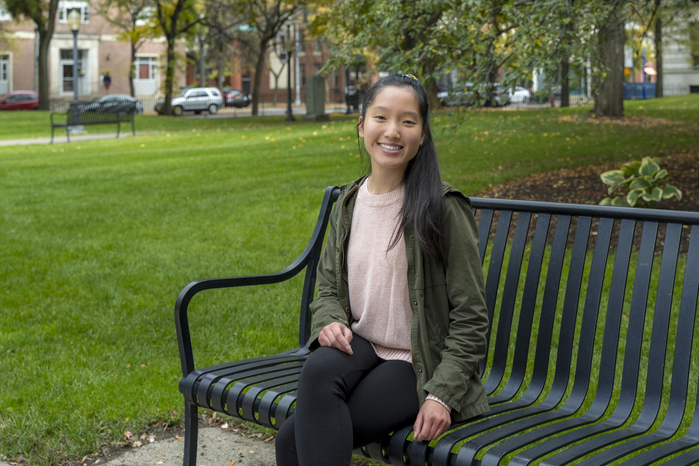 A Women's Institute Ambassador sitting on a bench on the Troy Sage campus