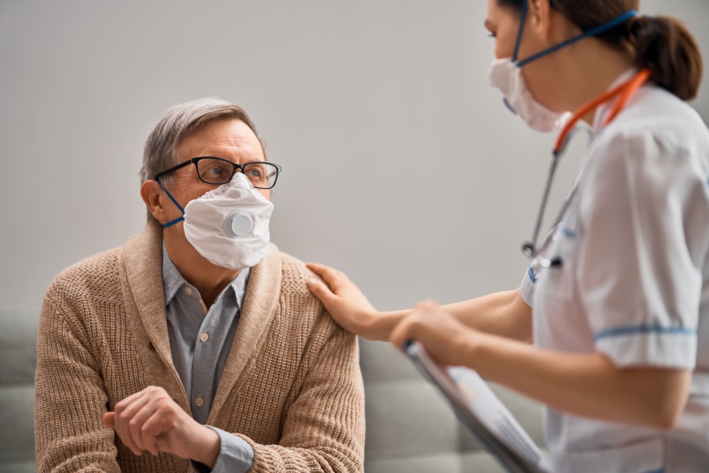 health professional speaking with patient wearing a mask