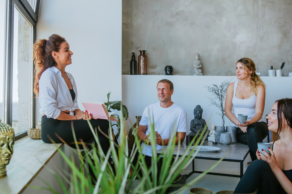 Wellness coach talking with a group of young people in a circle. 