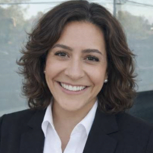 Woman smiling at camera dressed professionally