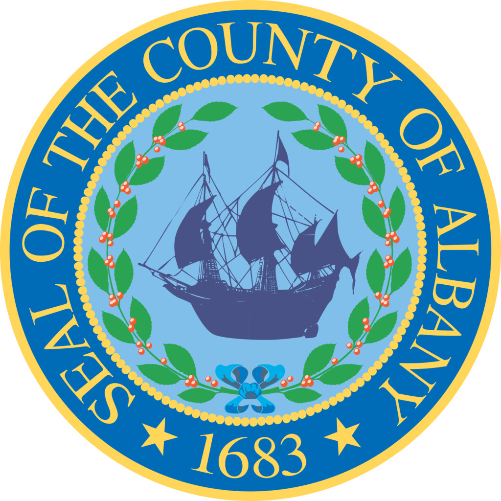 round seal with boat in the center and text around it that reads Seal of the county of Albany 1683