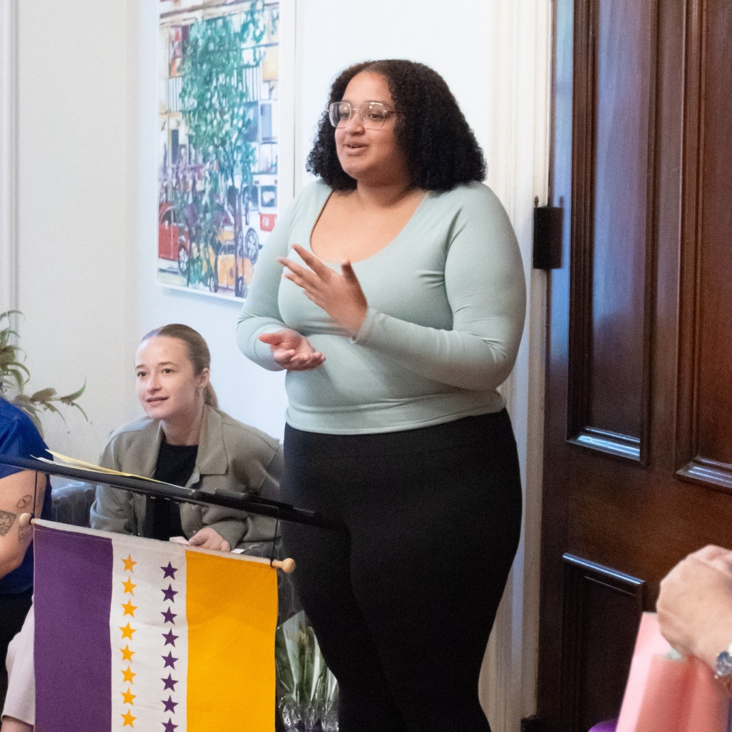 person standing and speaking to a group