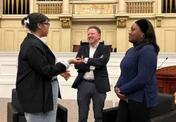Russell Sage College alumna Natoria Carey talking with President Matt Shaftel