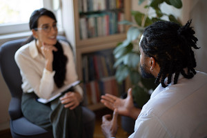 Psychologist speaking with a client during a counseling session, representing career paths in mental health and therapy with a psychology degree.