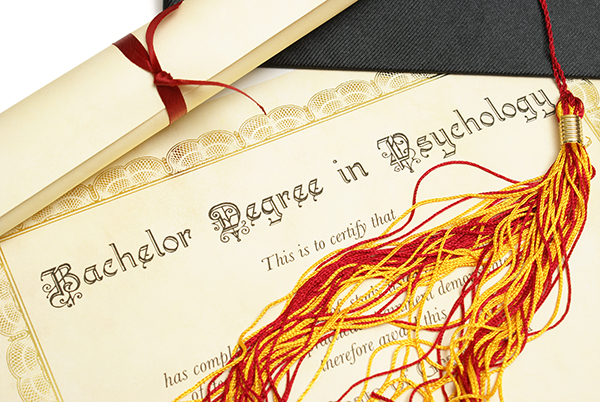 Close-up of a psychology degree diploma with a graduation cap and tassel, symbolizing careers and education opportunities in psychology.