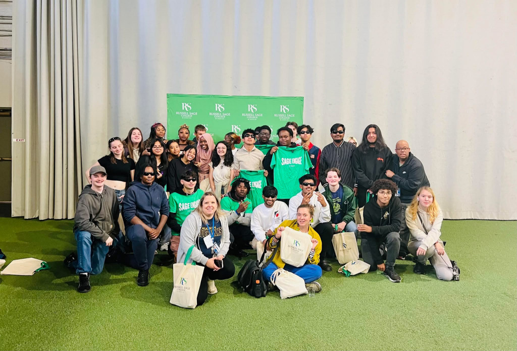 Large group of students in front of a green Russell Sage banner.