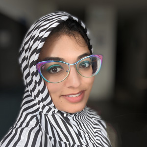 Professional person wearing colorful glasses while smiling at the camera