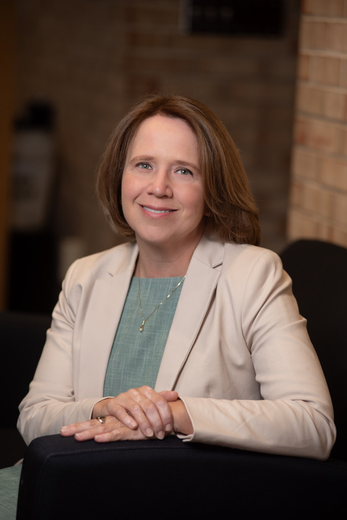 person dressed professionally smiling at camera