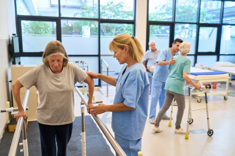Physical therapy doctoral students assist seniors with strength and mobility exercises in a rehabilitation facility. 
