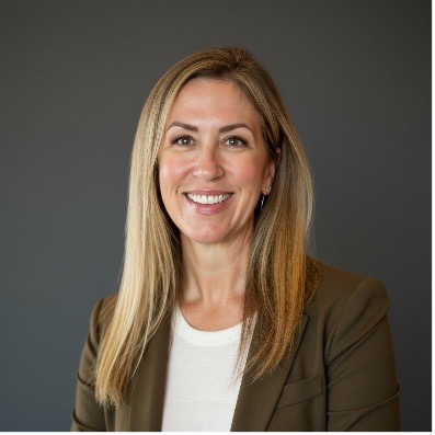 woman dressed professionally indoors smiling at the camera