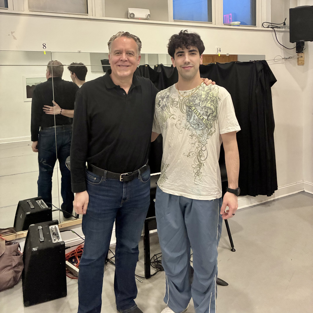 Two men standing together in a studio space