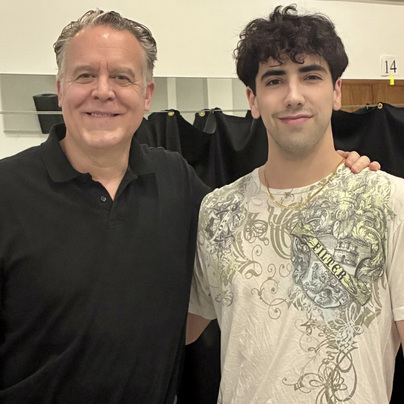 Two men standing together in a studio space