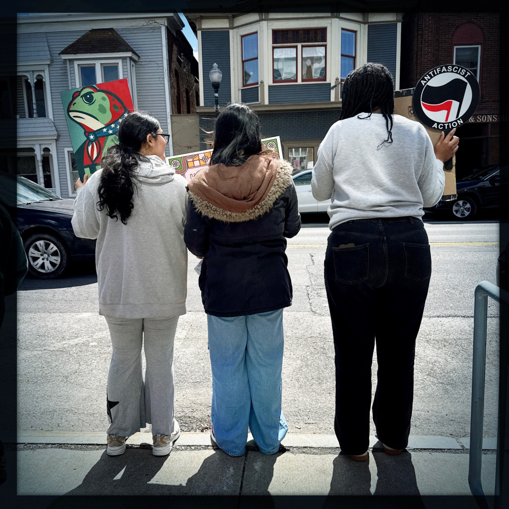 Women ambassadors and RSC Alumnaei holding protest signs at Seneca Falls on April 11 in the Women’s Rights National Historic Park