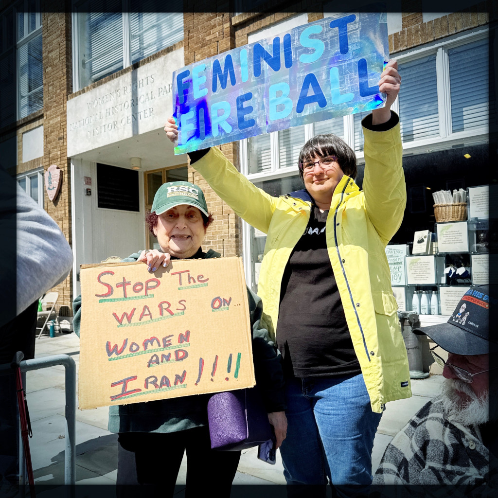 Women ambassadors and RSC Alumnaei holding protest signs at Seneca Falls on April 11 in the Women’s Rights National Historic Park