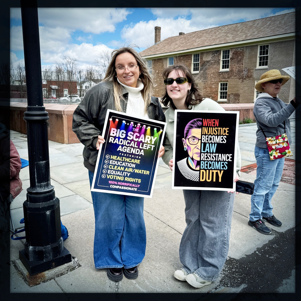 Women ambassadors and RSC Alumnaei holding protest signs at Seneca Falls on April 11 in the Women’s Rights National Historic Park
