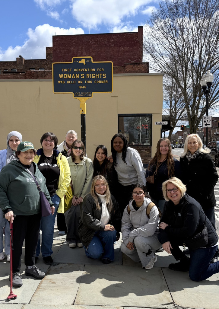 Women ambassadors and RSC Alumnaei smiling for group photo at Seneca Falls on April 11 in the Women’s Rights National Historic Park