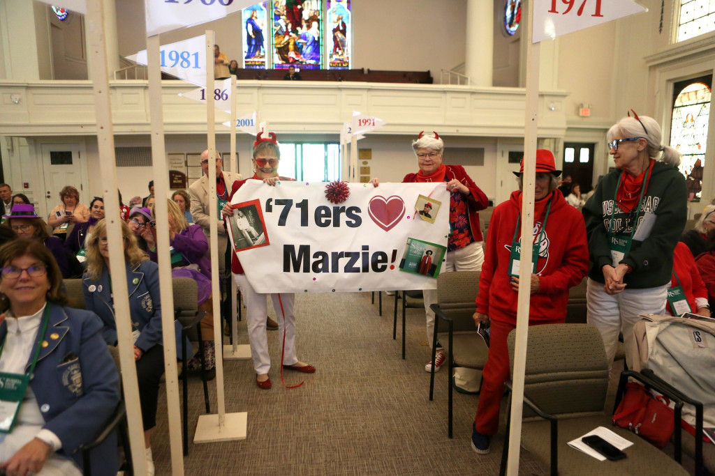 Two women dressed in red holding banner that says "'71ers (heart symbol) Marzie!